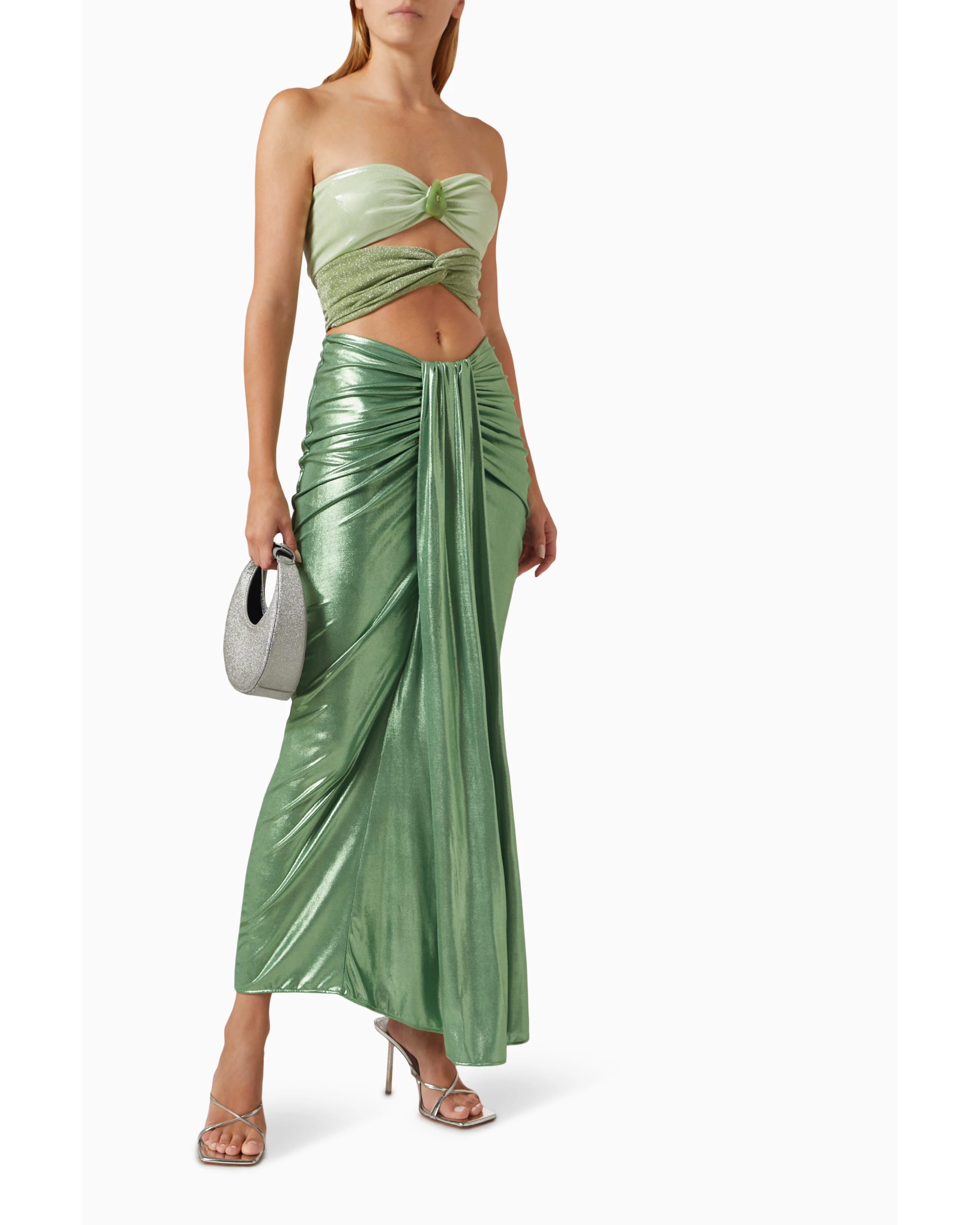 Woman wearing sage green ruched cutout maxi dress with metallic finish and strappy sandals — Baobab | Endless UAE
