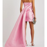 Pink strapless mini dress with dramatic draped overskirt train in lustrous satin fabric — Solace London | Endless UAE