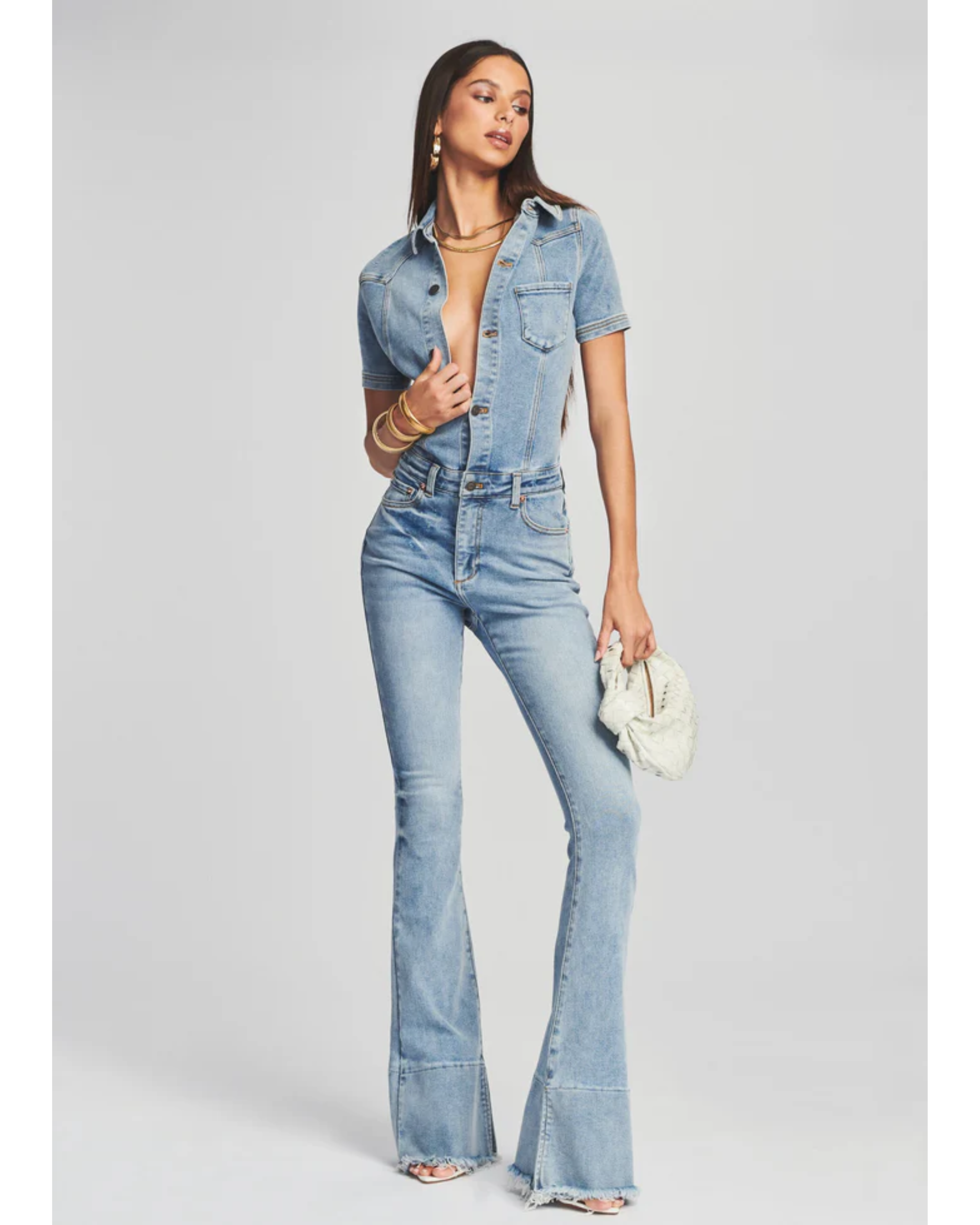 Woman wearing light blue denim Fallon Jumpsuit with short sleeves and flared legs — SER.O.YA | Endless UAE