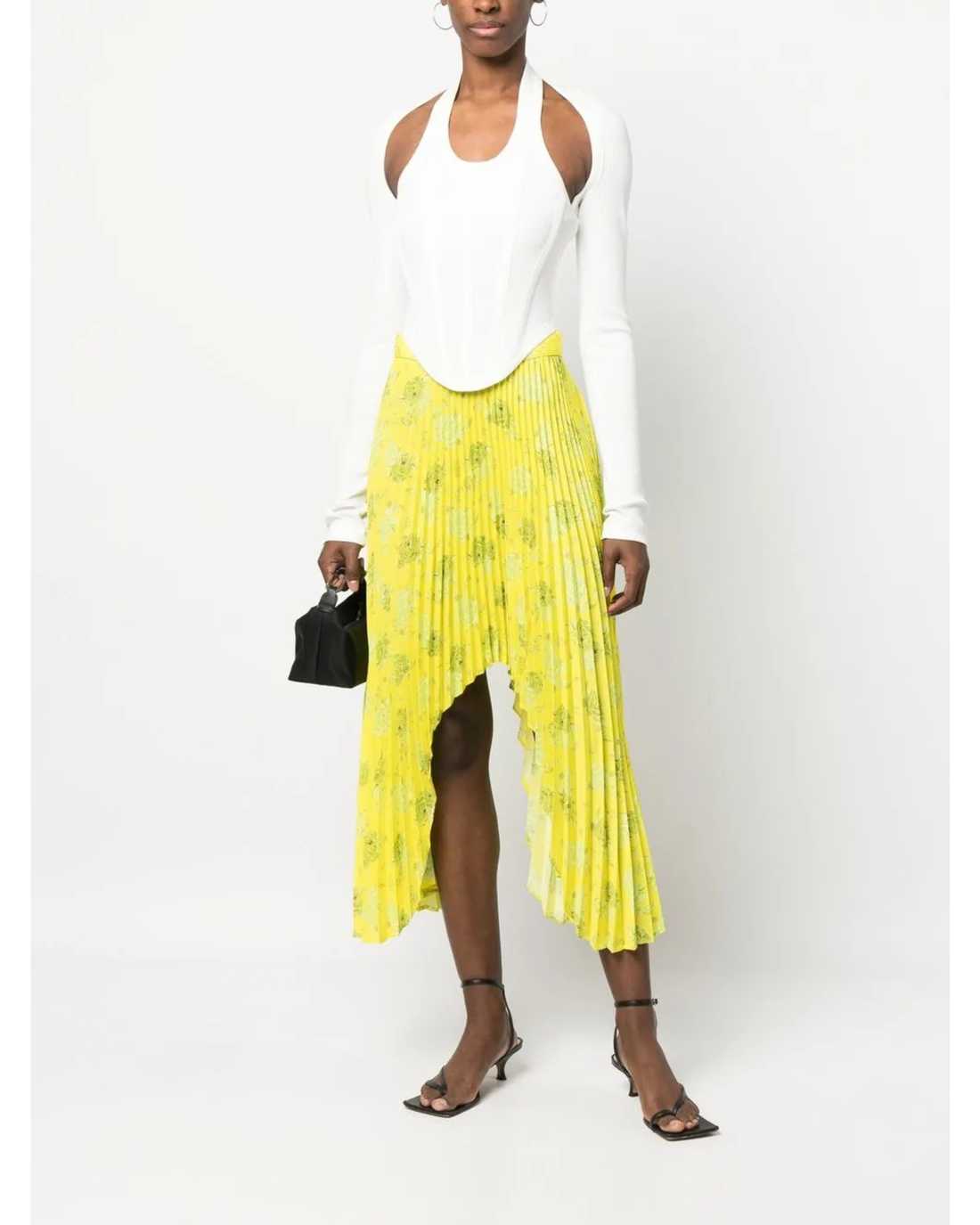 Yellow pleated floral midi skirt with asymmetric hem paired with white tank top and cardigan — Rokh | Endless UAE