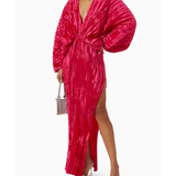 Woman wearing a fuchsia crinkled pleated oversized maxi dress with wrap front and voluminous sleeves — L'IDÉE | Endless UAE