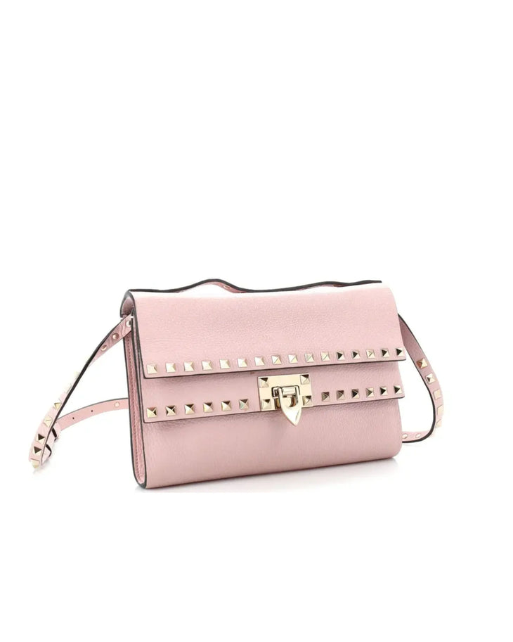 Valentino Garavani pink leather Rockstud crossbody bag with gold pyramid studs and flip lock closure — Valentino Garavani | Endless UAE
