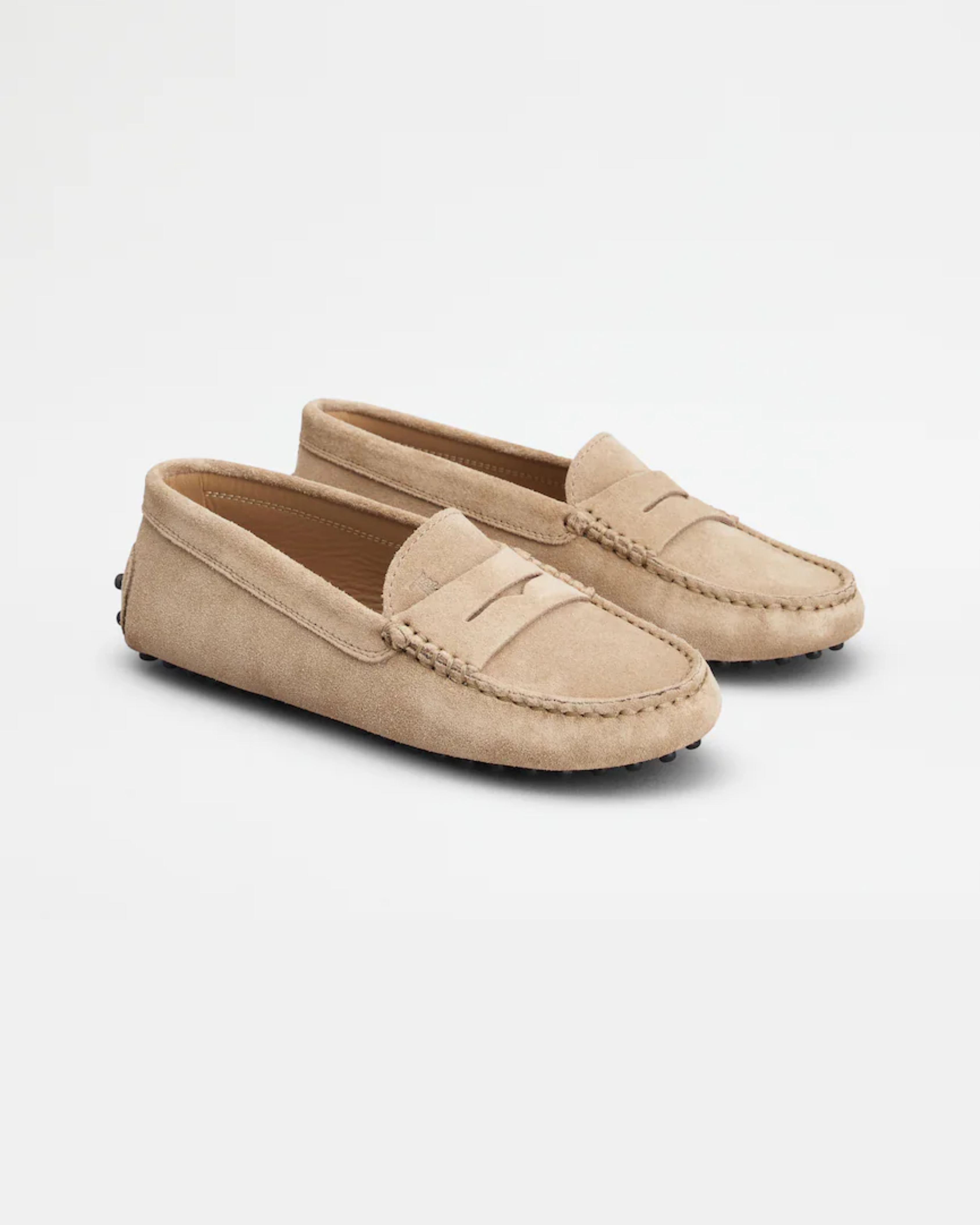 Beige suede junior driving loafer with black rubber sole and stitched detailing — Tod's | Endless UAE
