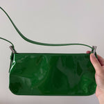 Dulce Patent Leather Shoulder Bag in vibrant green, held up against neutral background — By Far | Endless UAE