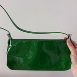 Dulce Patent Leather Shoulder Bag in vibrant green, held up against neutral background — By Far | Endless UAE