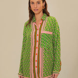 Woman wearing green patterned button-up romper with striped trim and brown accessories — Farm Rio | Endless UAE
