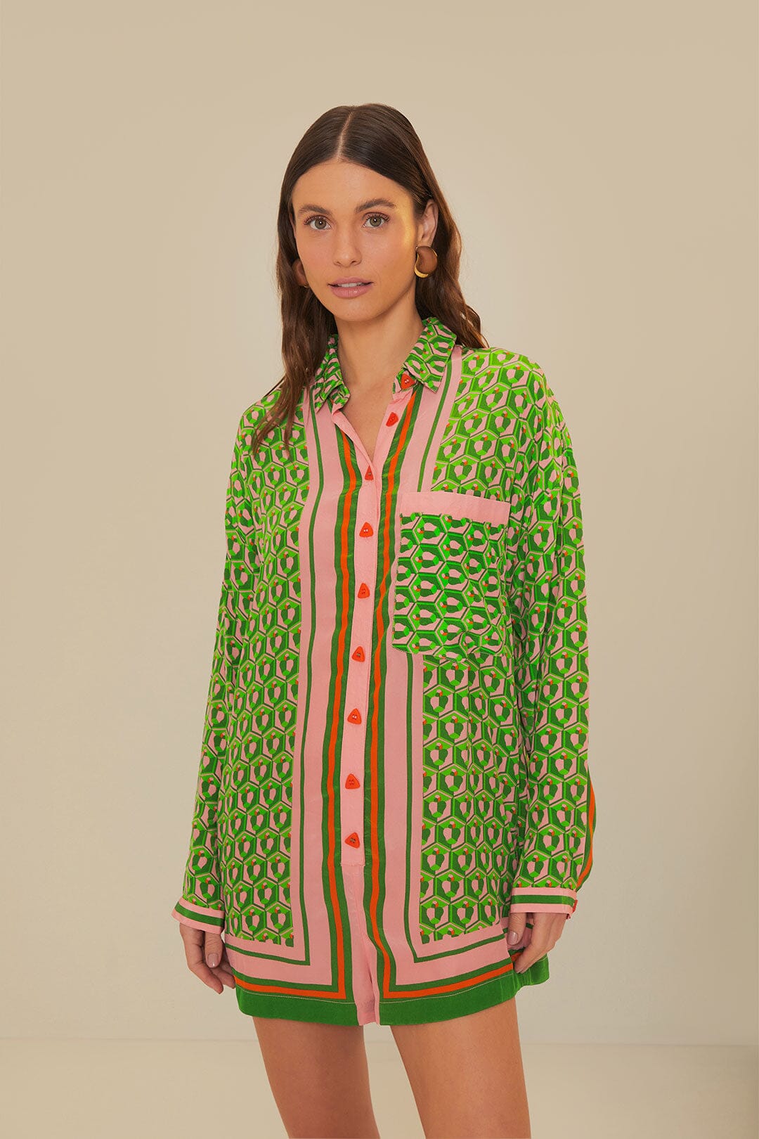 Woman wearing green patterned button-up romper with striped trim and brown accessories — Farm Rio | Endless UAE