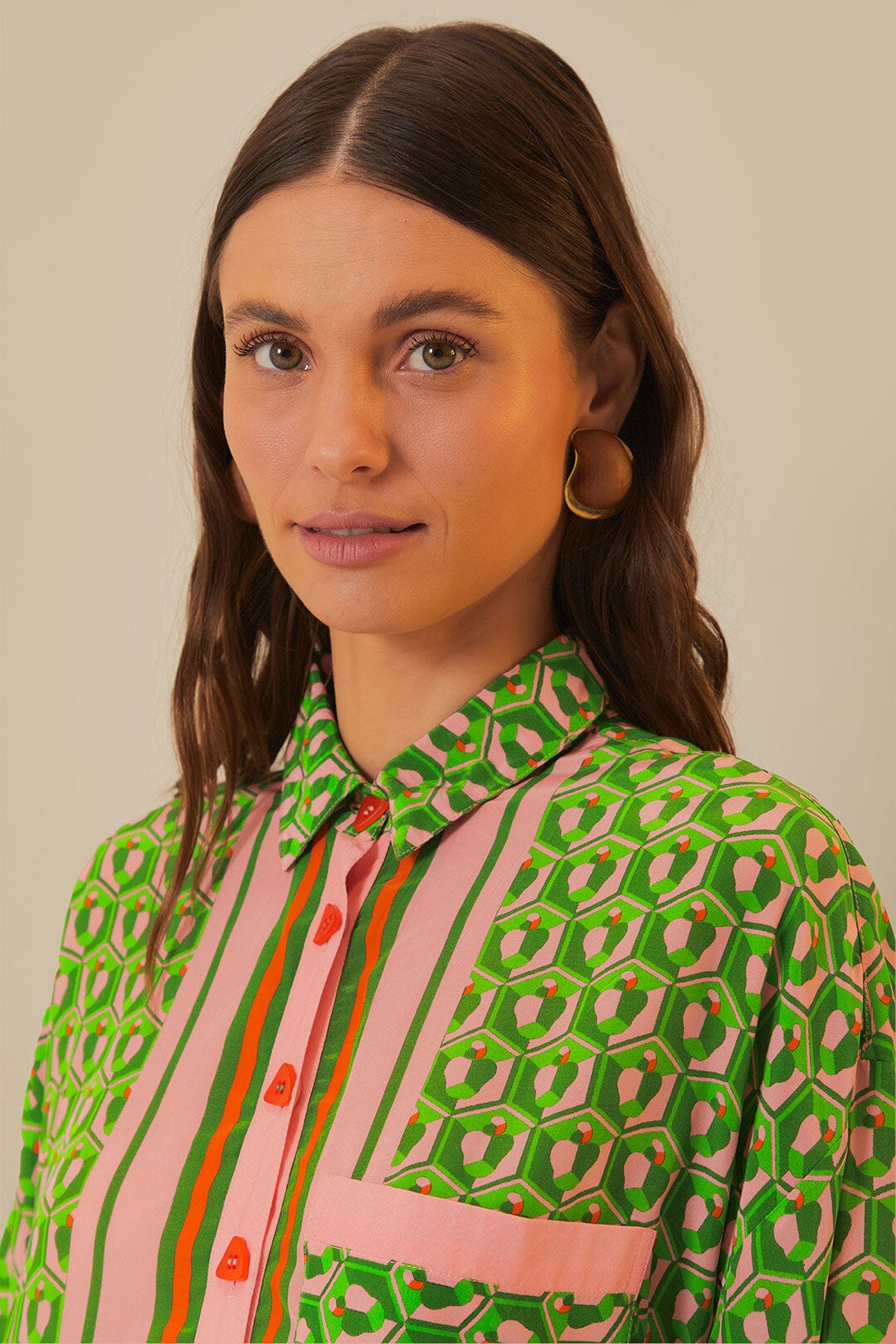 Woman wearing green patterned button-up romper with striped trim and brown accessories — Farm Rio | Endless UAE