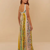 Back view of woman wearing a sleeveless maxi dress with colorful vertical floral stripes in yellow, pink and green — Farm Rio | Endless UAE