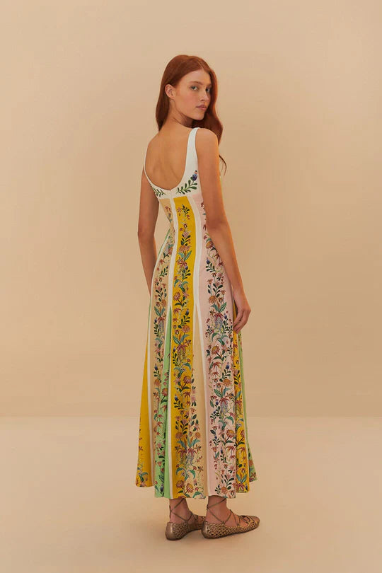 Back view of woman wearing a sleeveless maxi dress with colorful vertical floral stripes in yellow, pink and green — Farm Rio | Endless UAE