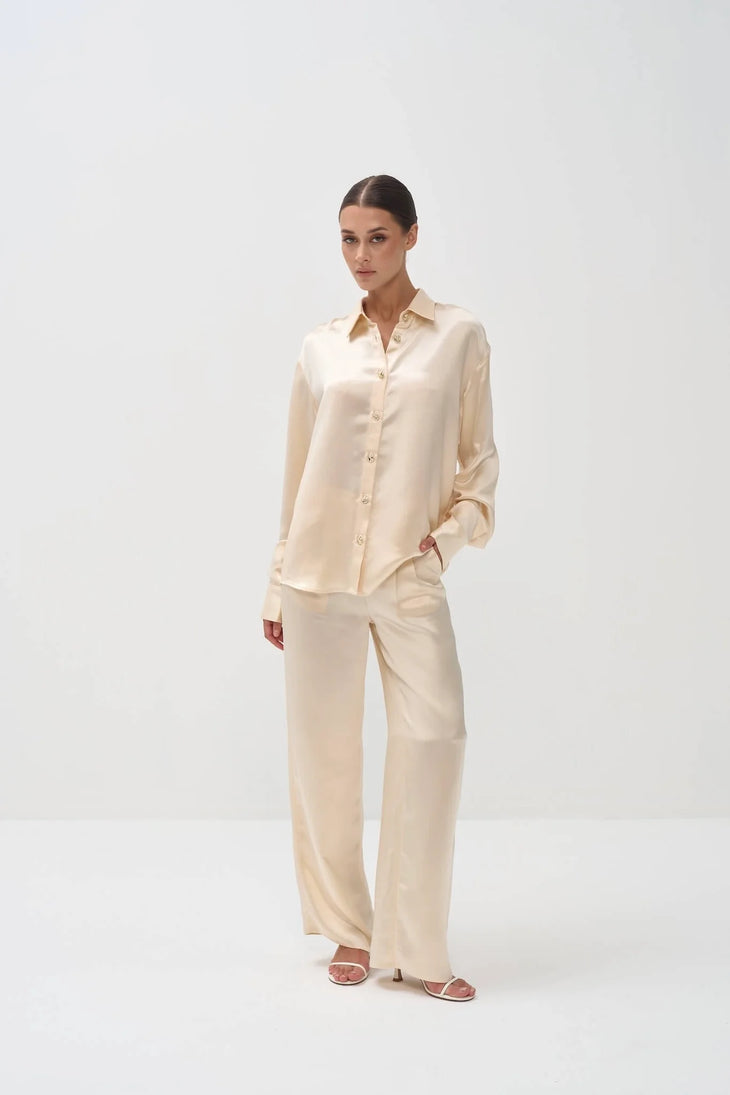 Elegant cream silk shirt and pants set loungewear outfit with button-down top and wide-leg trousers — Nora The Label | Endless UAE