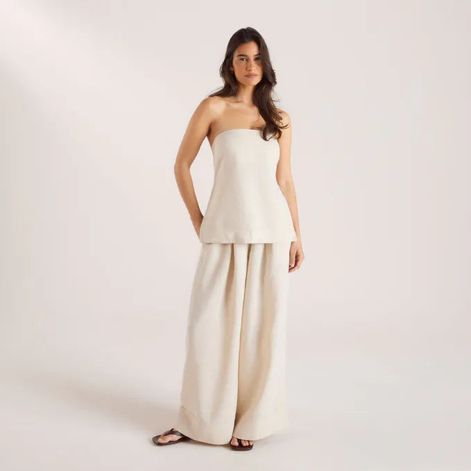 Woman wearing cream linen blend strapless blouse and wide-leg pants — Leo Lin | Endless UAE