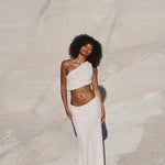 Woman wearing white sequin one-shoulder crop top and matching maxi skirt set against neutral background — Label Loft London | Endless UAE
