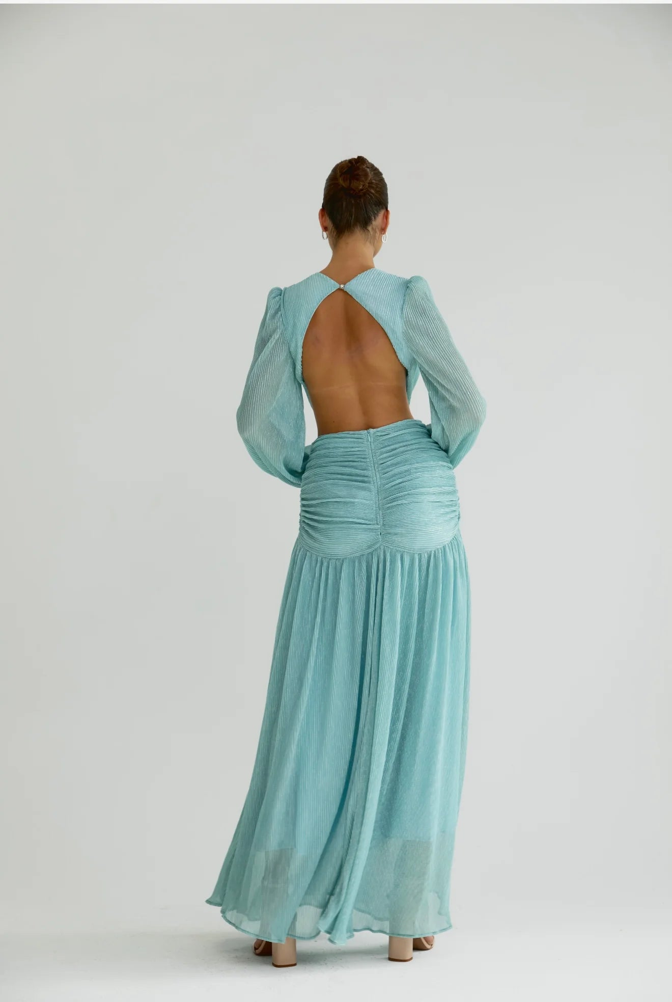 Woman wearing a flowing light blue wrap dress with long sleeves and cutout waist detail — Anne Louise Boutique | Endless UAE