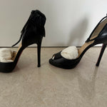 Black leather peep-toe platform pumps with bow detail and lace-up ankle straps — Christian Louboutin | Endless UAE