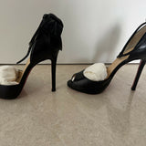 Black leather peep-toe platform pumps with bow detail and lace-up ankle straps — Christian Louboutin | Endless UAE