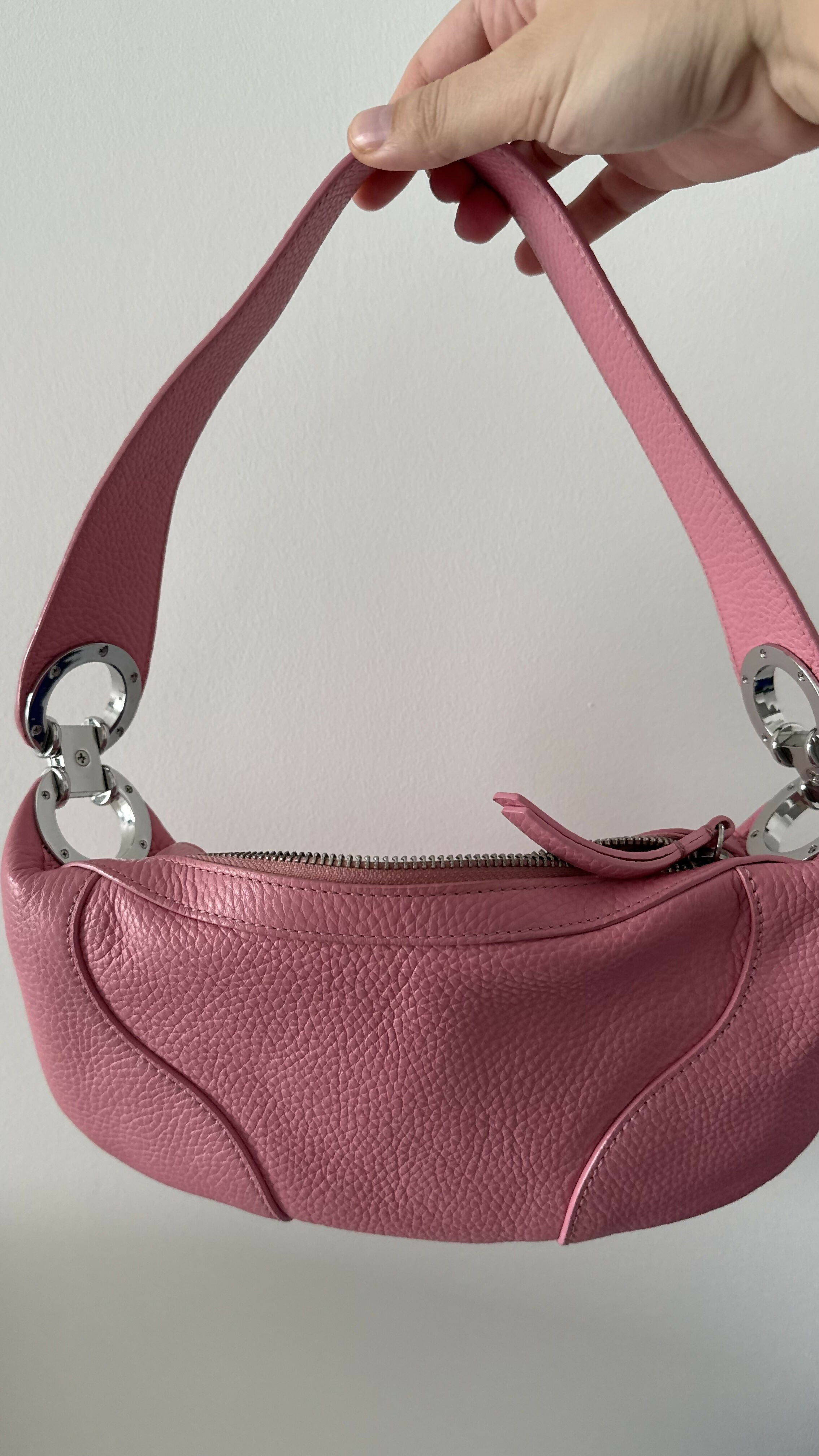 Pink leather mini shoulder bag with dual handles displayed against neutral background — By Far | Endless UAE