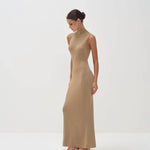 Elegant sleeveless gold maxi dress with mock neck, fitted silhouette, worn with strappy heels — Nora The Label | Endless UAE