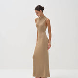 Elegant sleeveless gold maxi dress with mock neck, fitted silhouette, worn with strappy heels — Nora The Label | Endless UAE