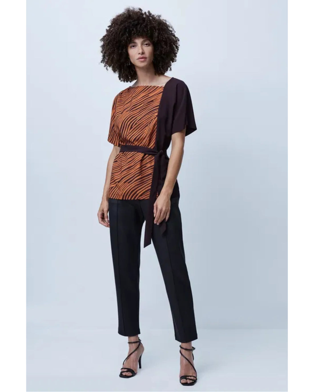 Woman wearing orange zebra stripe top with black sleeves and black cropped pants — French Connection | Endless UAE