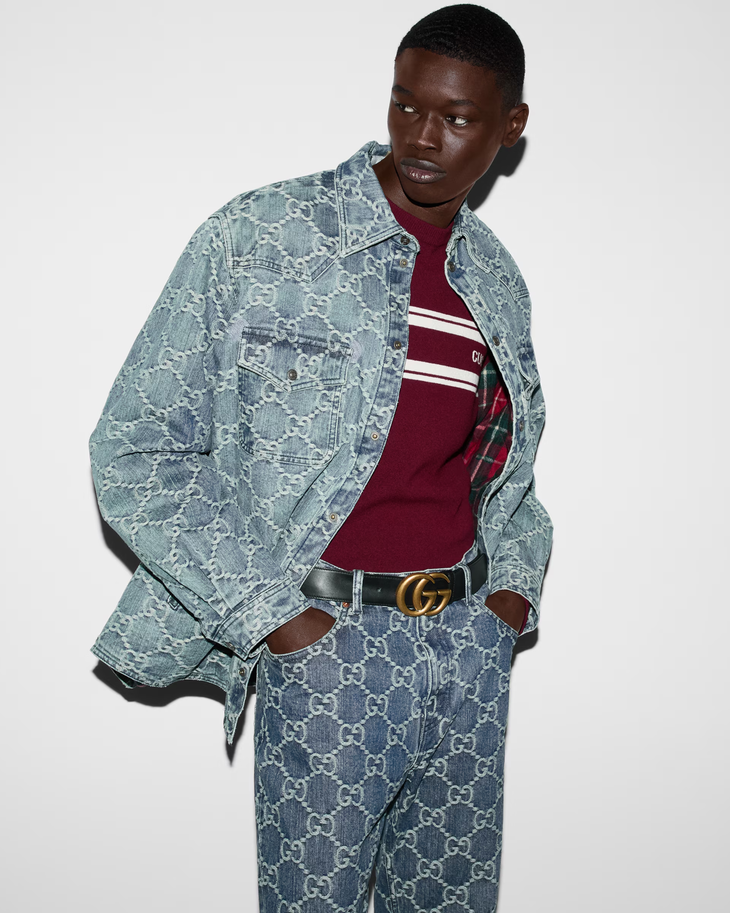 Black leather belt with double G gold-toned buckle worn with denim jacket and burgundy striped shirt — Gucci | Endless UAE