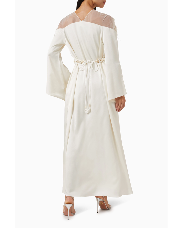 Ivory maxi dress with sheer mesh shoulders, bell sleeves, and braided rope belt tie at waist, shown from back — Nass | Endless UAE