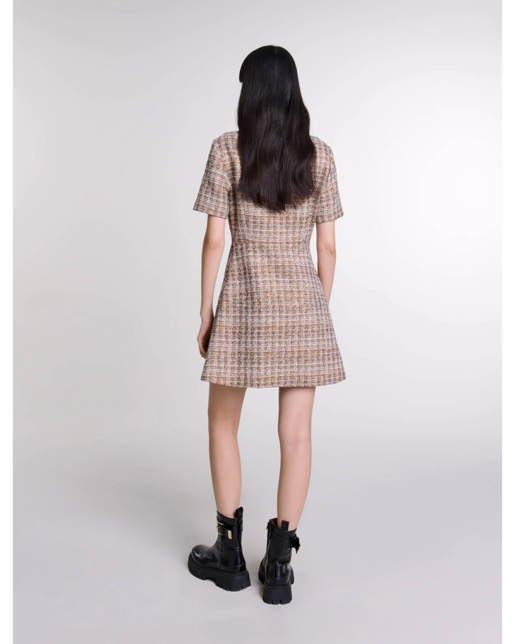 Rear view of woman wearing beige checked mini dress with short sleeves and black combat boots — Maje | Endless UAE