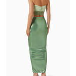 Woman wearing sage green ruched cutout maxi dress with metallic finish and strappy sandals — Baobab | Endless UAE