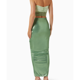 Woman wearing sage green ruched cutout maxi dress with metallic finish and strappy sandals — Baobab | Endless UAE