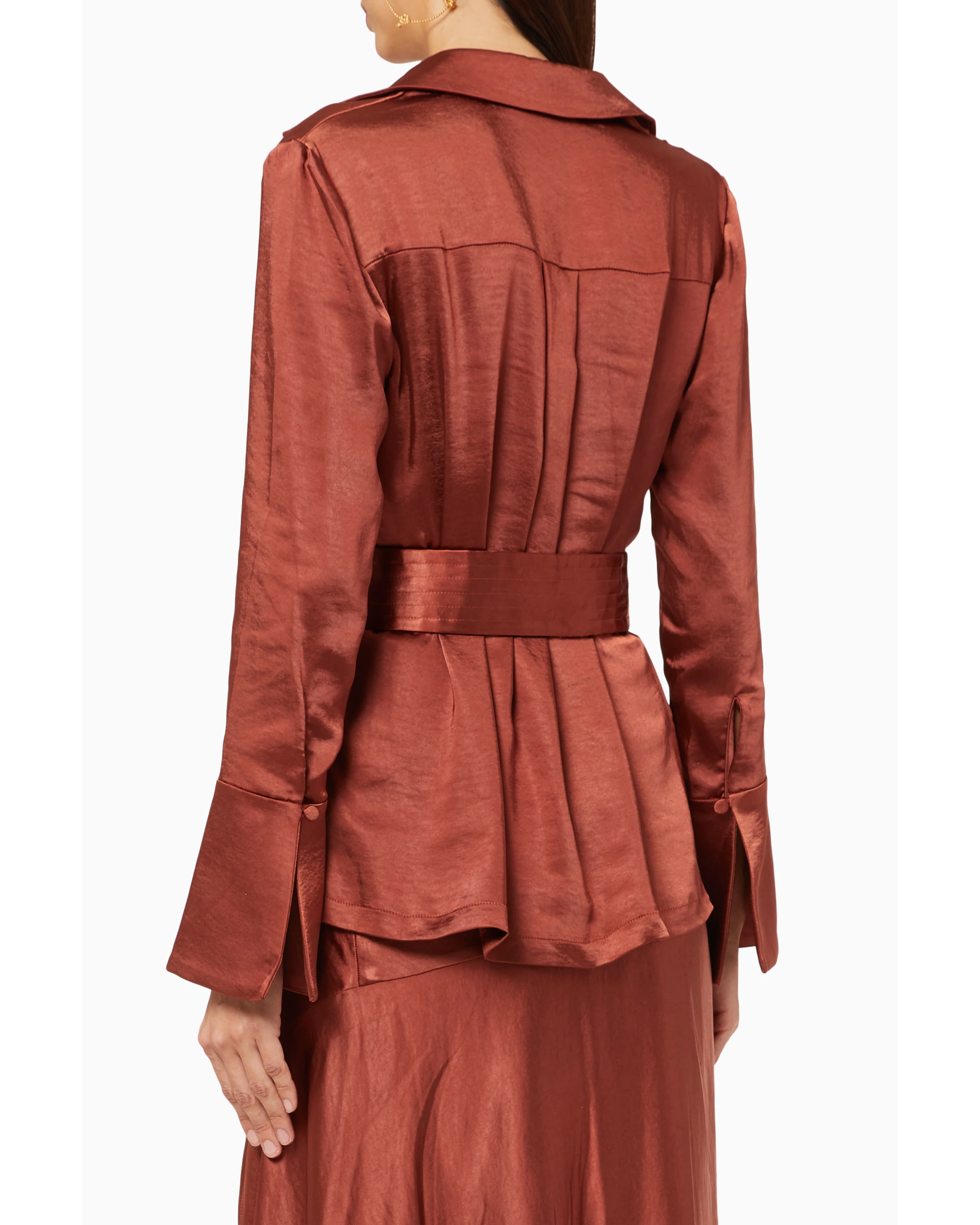 Rust-colored satin blazer with pleated back detail and matching belt, worn from behind — Significant Other | Endless UAE