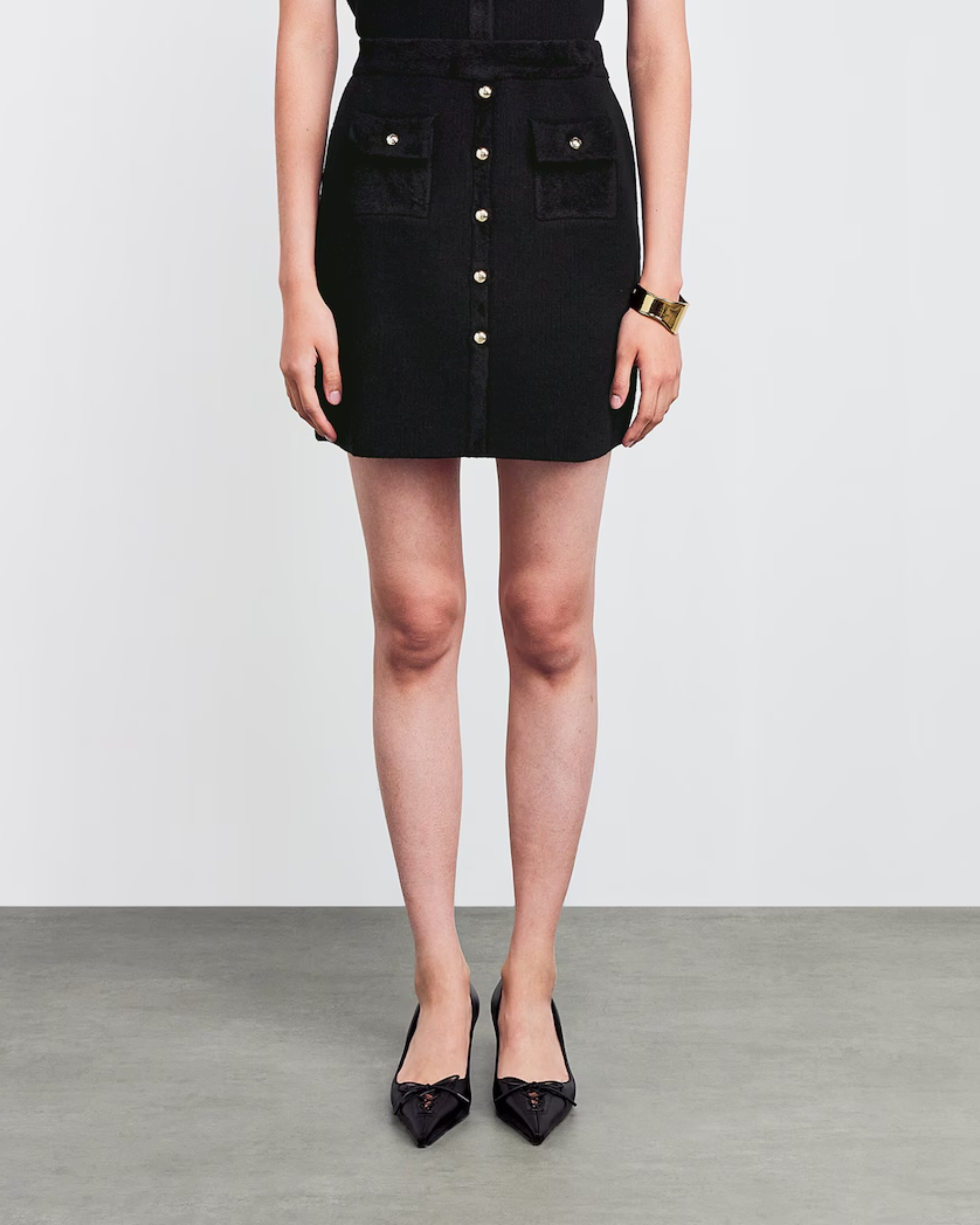 Black suede mini skirt with snap button closure and chest pockets — Claudie Pierlot | Endless UAE