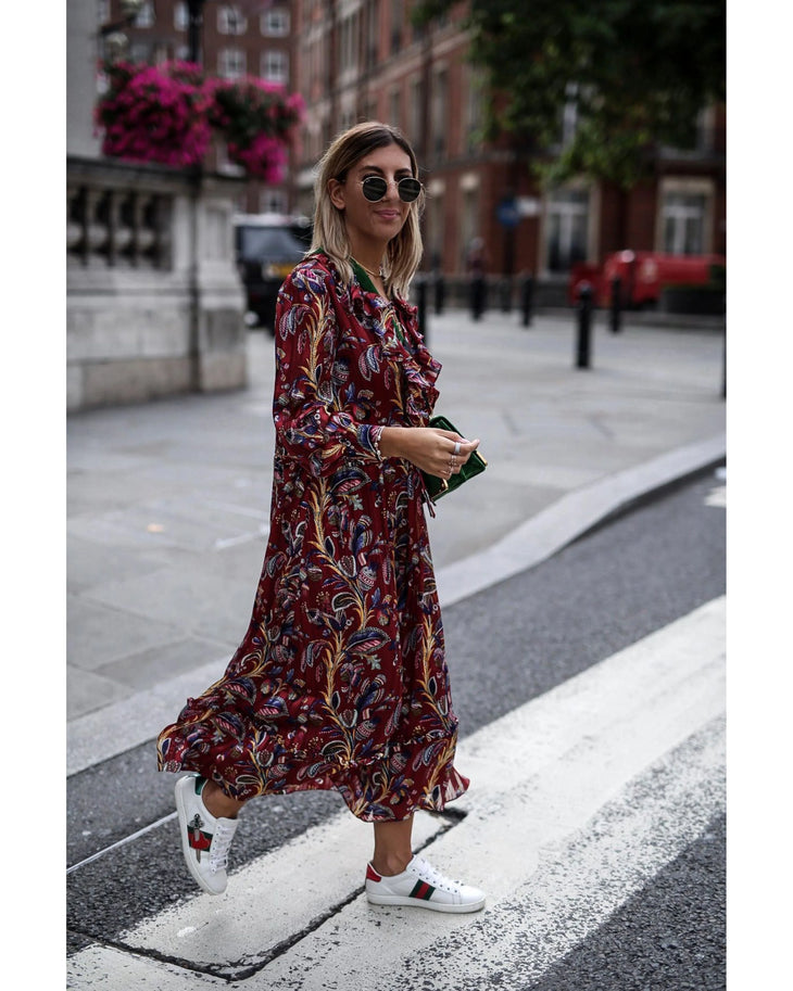 Woman wearing burgundy paisley maxi dress with white sneakers and sunglasses in urban setting — & Other Stories | Endless UAE