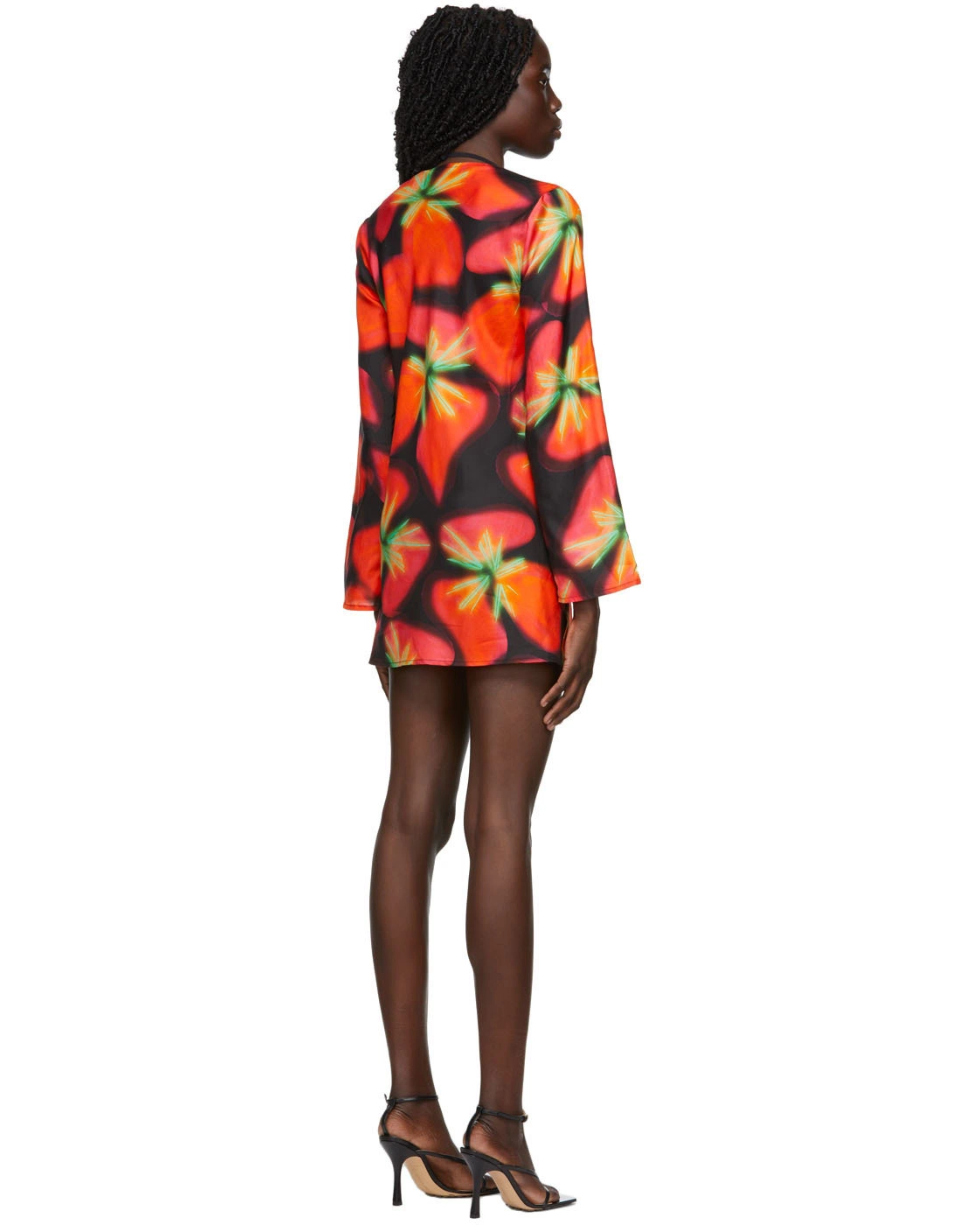Woman wearing vibrant red and orange strawberry print blazer dress with green handbag — Louisa Ballou | Endless UAE