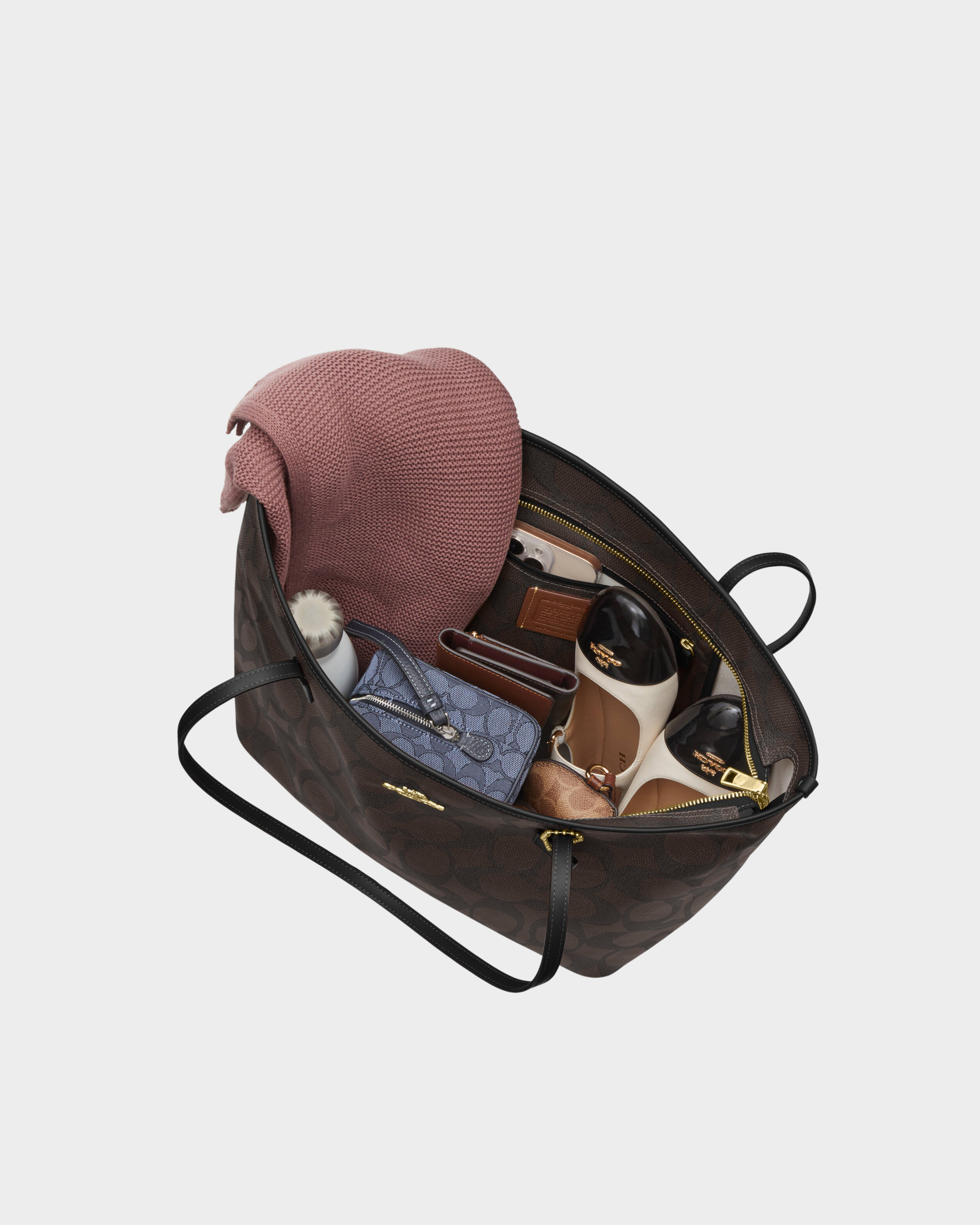 Black leather tote bag with dual handles and Coach branding — Coach | Endless UAE