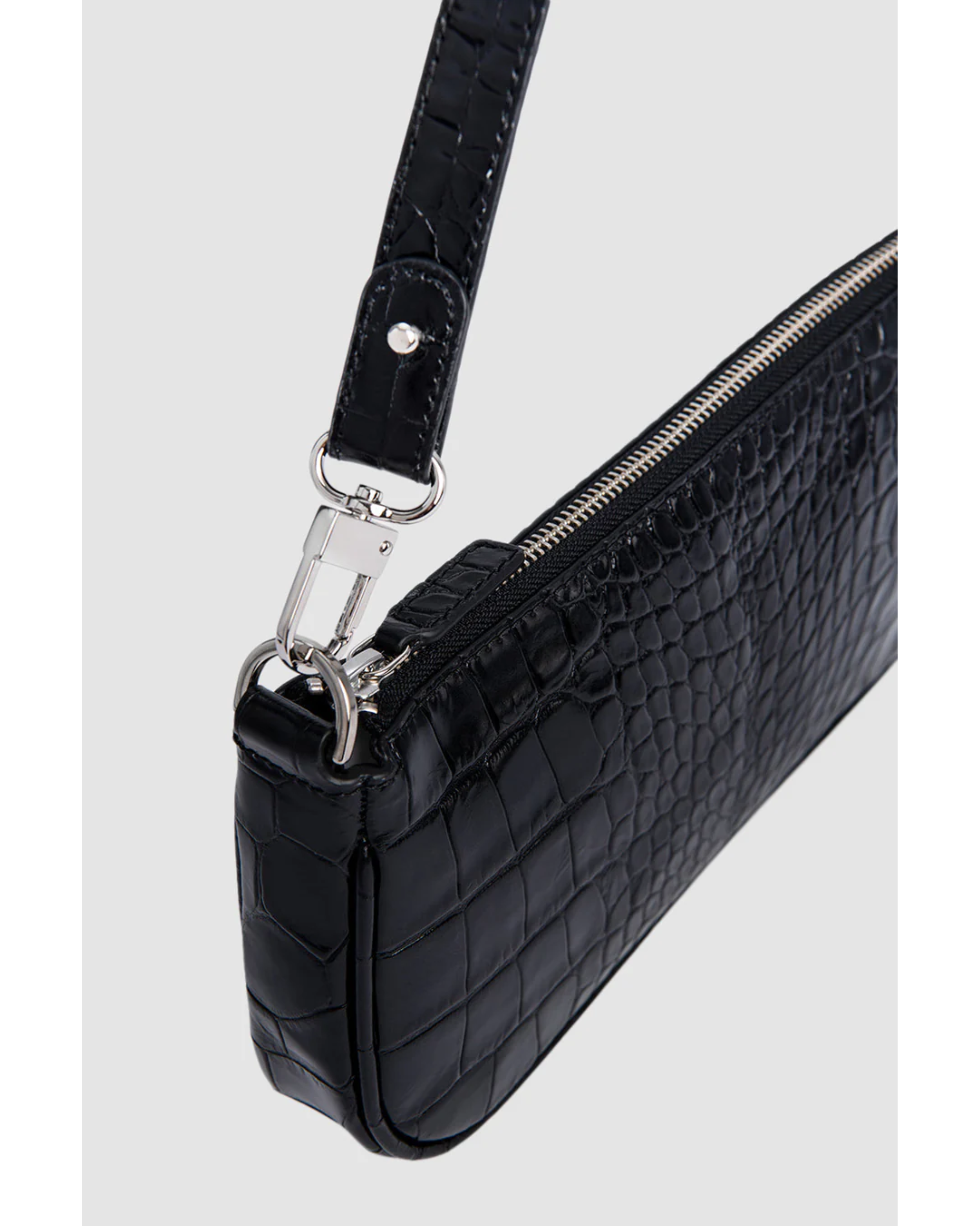 Black crocodile embossed leather shoulder bag held in hand against white background — By Far | Endless UAE