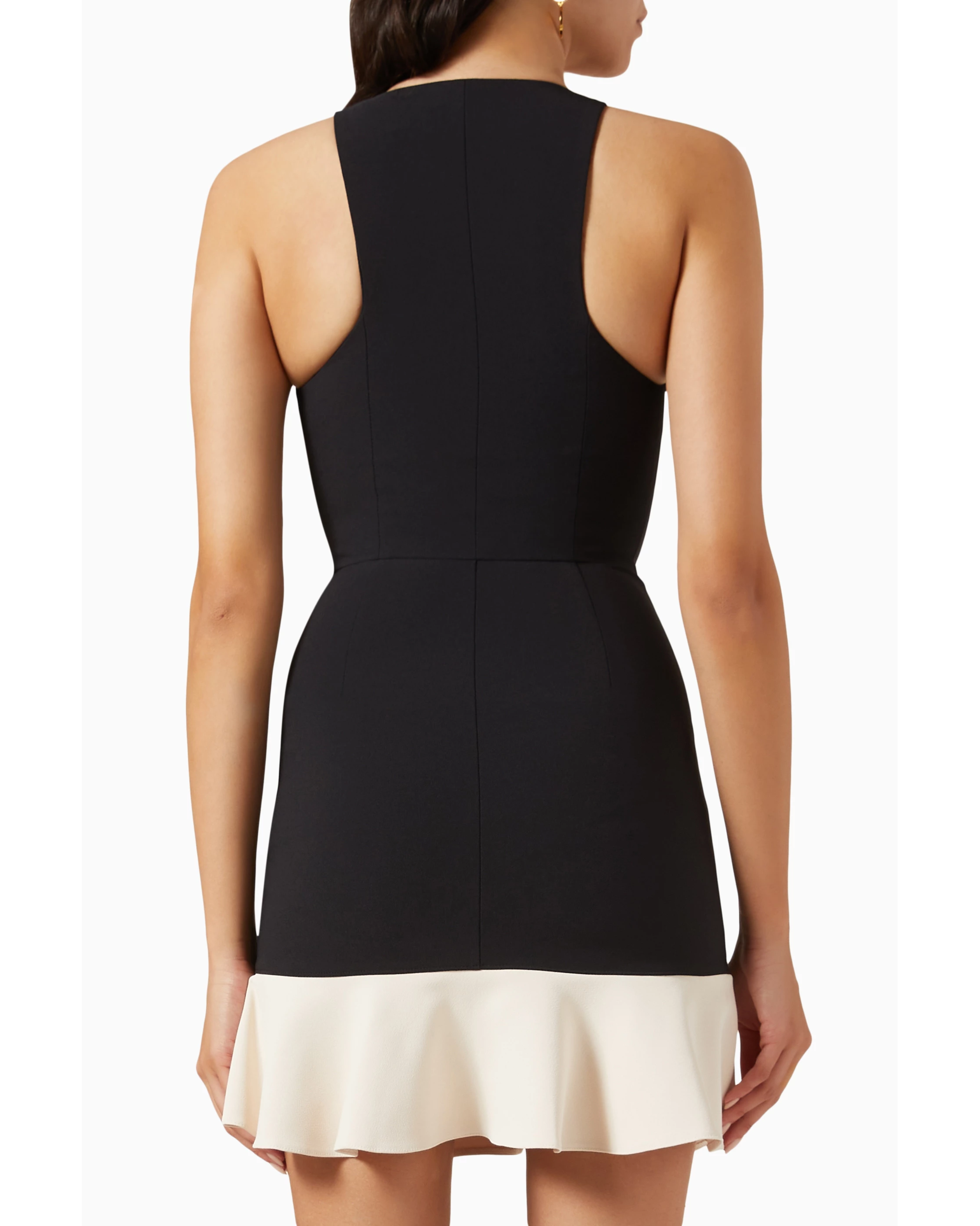 Woman wearing black and cream mini dress with gold turn-lock belt and chain shoulder bag — Elisabetta Franchi | Endless UAE
