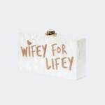 Wifey For Lifey clear clutch bag with gold glitter text and gold-tone hardware — Sophia Webster | Endless UAE