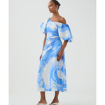 Woman wearing blue and white abstract print Cadence Ruched Midi Dress with puffed sleeves and white slides — Aje | Endless UAE