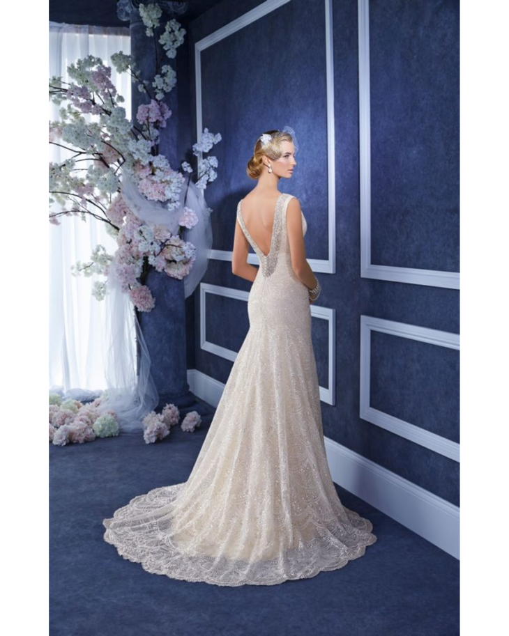 Champagne lace mermaid wedding gown with deep V-back and train by bride in elegant interior — Ronald Joyce | Endless UAE