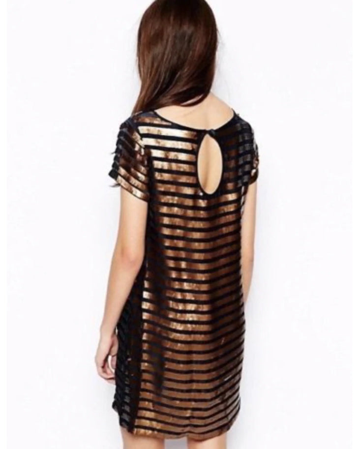 Woman wearing black and gold striped sequin shift dress with short sleeves — French Connection | Endless UAE