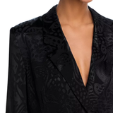 Woman wearing black leopard jacquard blazer and matching wide leg pants with accessories — Farm Rio | Endless UAE