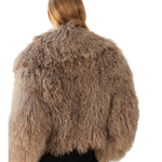 Woman wearing mocha fuzzy cropped jacket over black turtleneck and wide-leg trousers — Madame Magdalena | Endless UAE