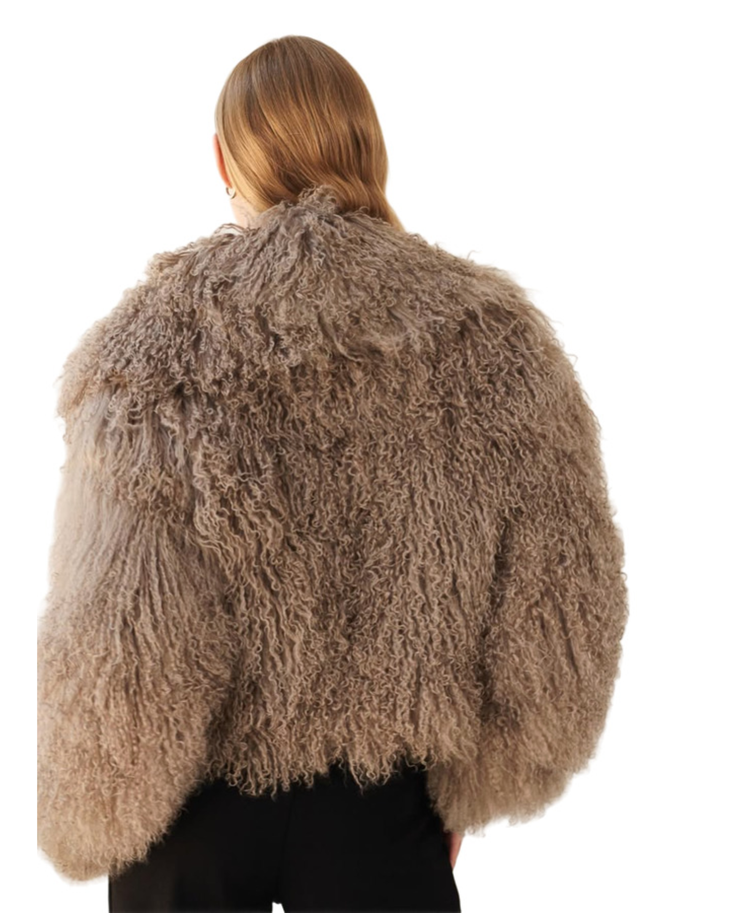 Woman wearing mocha fuzzy cropped jacket over black turtleneck and wide-leg trousers — Madame Magdalena | Endless UAE