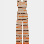 Woman wearing a colorful striped cotton jumpsuit with orange, brown and cream zigzag pattern — Missoni | Endless UAE