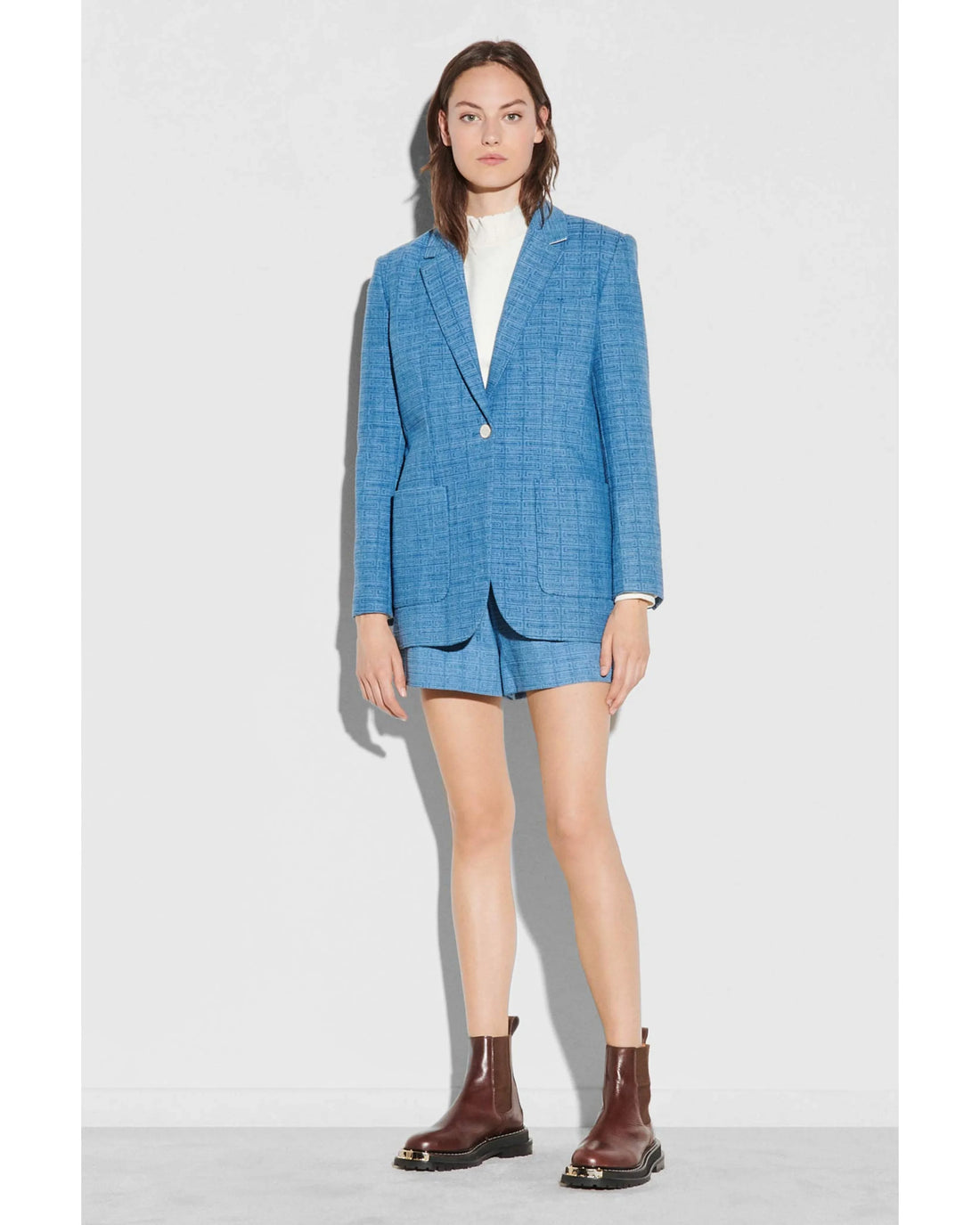 Blue geometric knit blazer worn with white shirt and burgundy boots — Sandro | Endless UAE