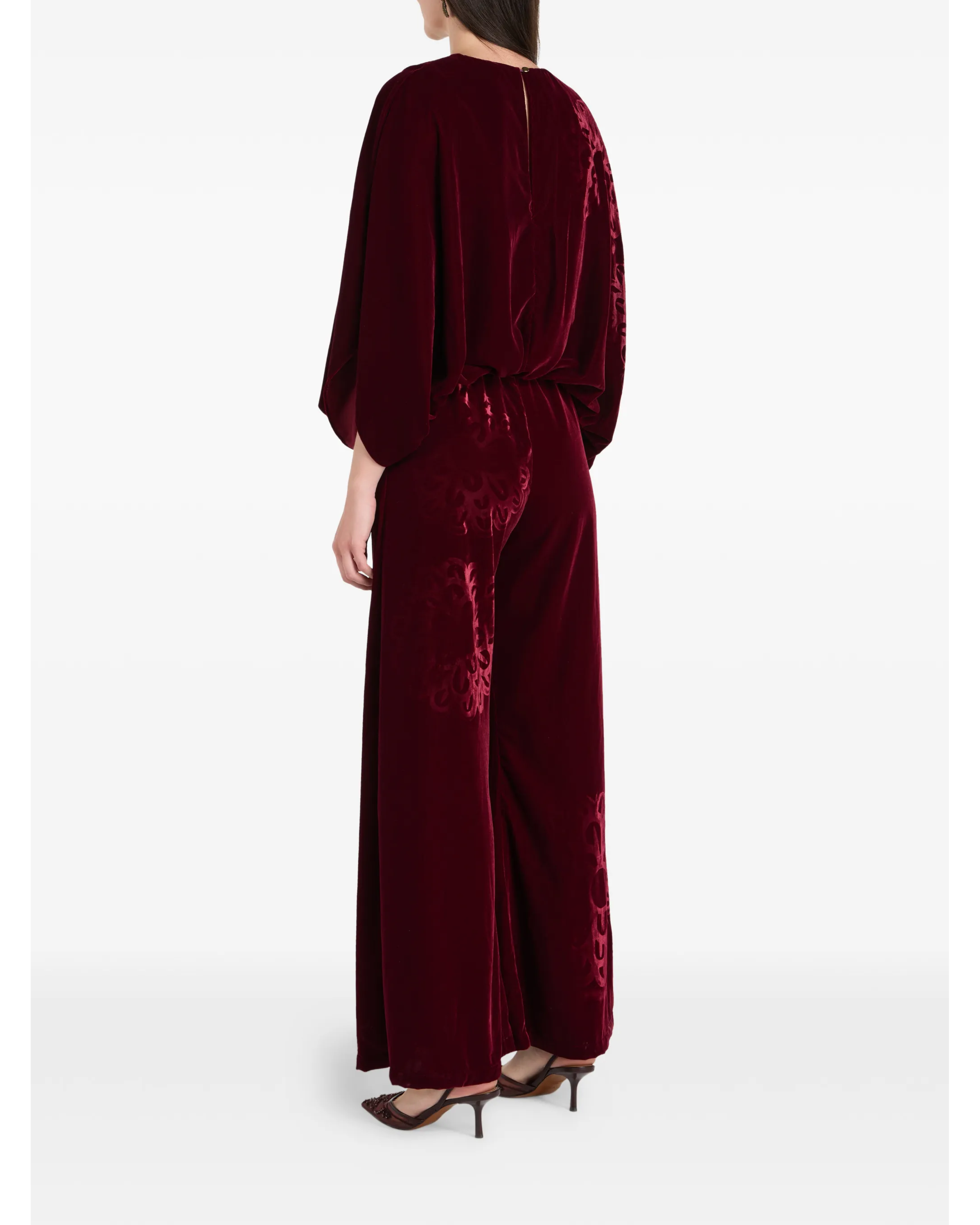 Woman wearing burgundy silk velvet jumpsuit with ornamental detailing and wide legs — Themis-Z | Endless UAE