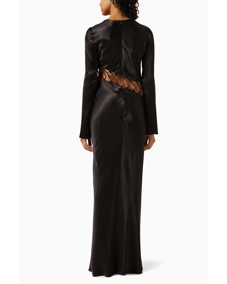 Black satin maxi dress with long sleeves and asymmetrical cutout waist detail, shown from back — Shona Joy | Endless UAE
