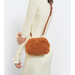 Gea Clutch in caramel brown textured fabric held in hand — TheMoire | Endless UAE