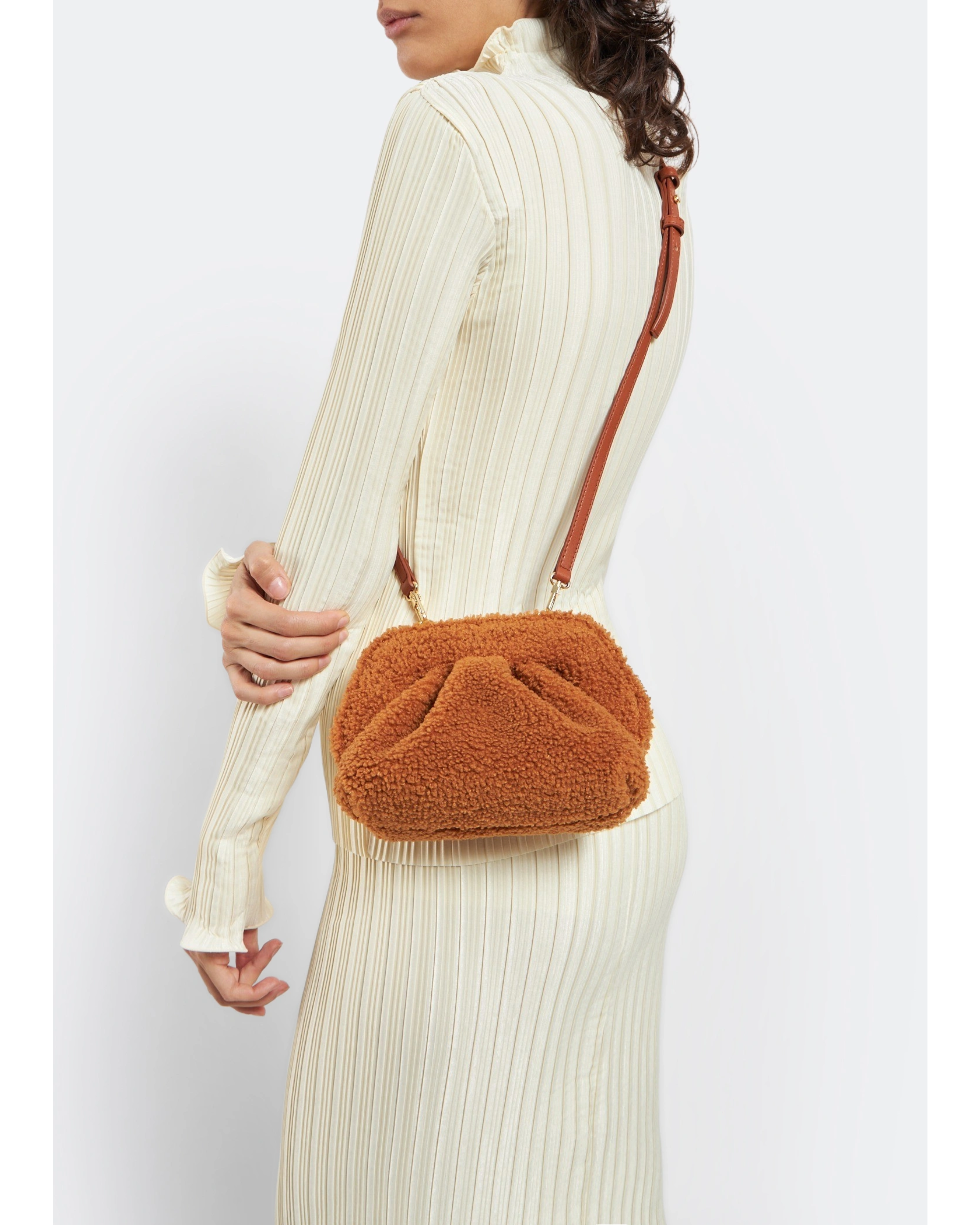 Gea Clutch in caramel brown textured fabric held in hand — TheMoire | Endless UAE