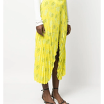 Yellow pleated floral midi skirt with asymmetric hem paired with white tank top and cardigan — Rokh | Endless UAE